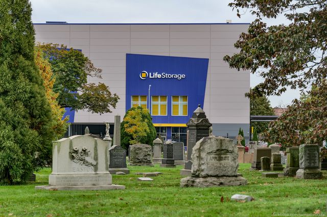 A photo of a "life storage" facility behind a graveyard